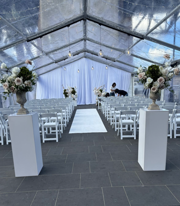 white square plinths and flowers placed on top